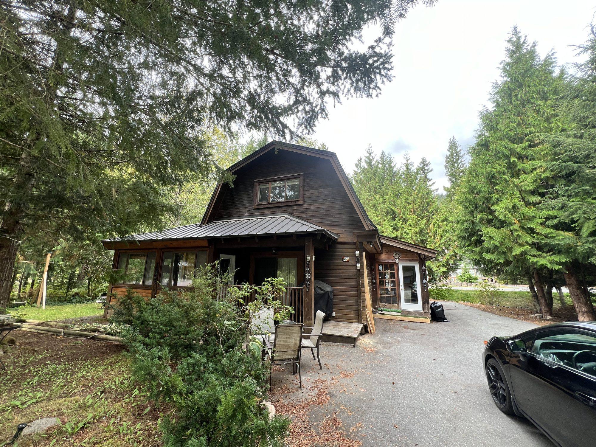 Front of the gambrel roofed log home at Black Tusk Village
