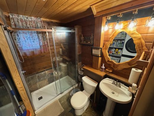 Main bathroom with a walk in shower, and the washer and dryer