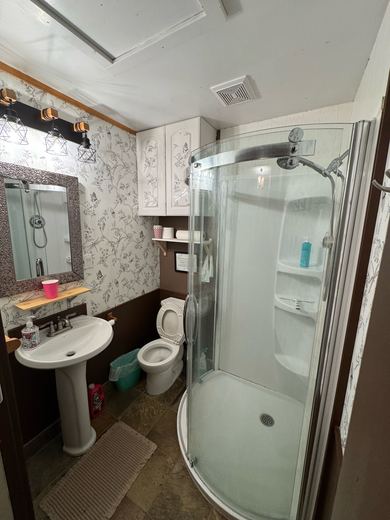 Second bathroom with a corner shower