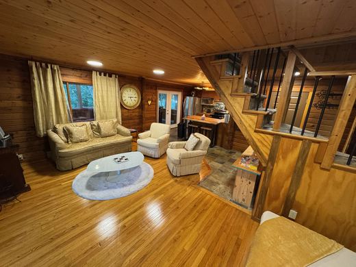 Living room looking through to the kitchen and the stone and timber staircase