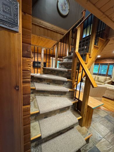 Stone tread staircase with timber and iron railings