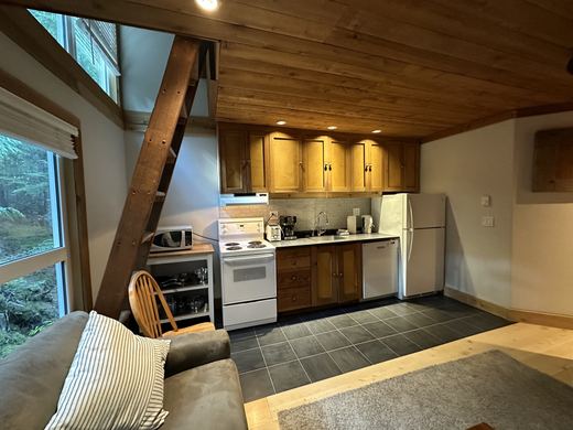 Kitchen with wood cabinets, slate tile floor, fridge, stove, dishwasher and microwave