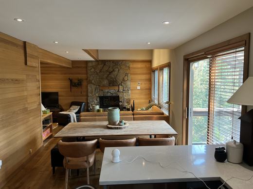 Dining area beside the fireplace with deck doors