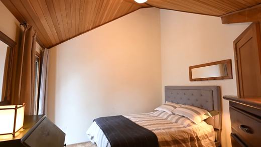 Second bedroom with queen bed and cedar ceiling